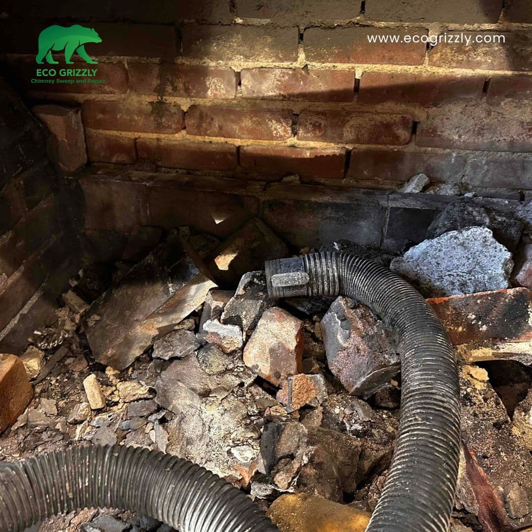 Damaged firebox interior showing cracked refractory bricks and worn mortar joints