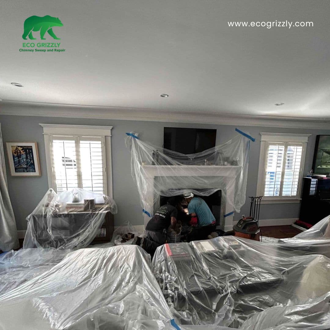 Site preparation before a chimney inspection with drop cloths and tools laid out