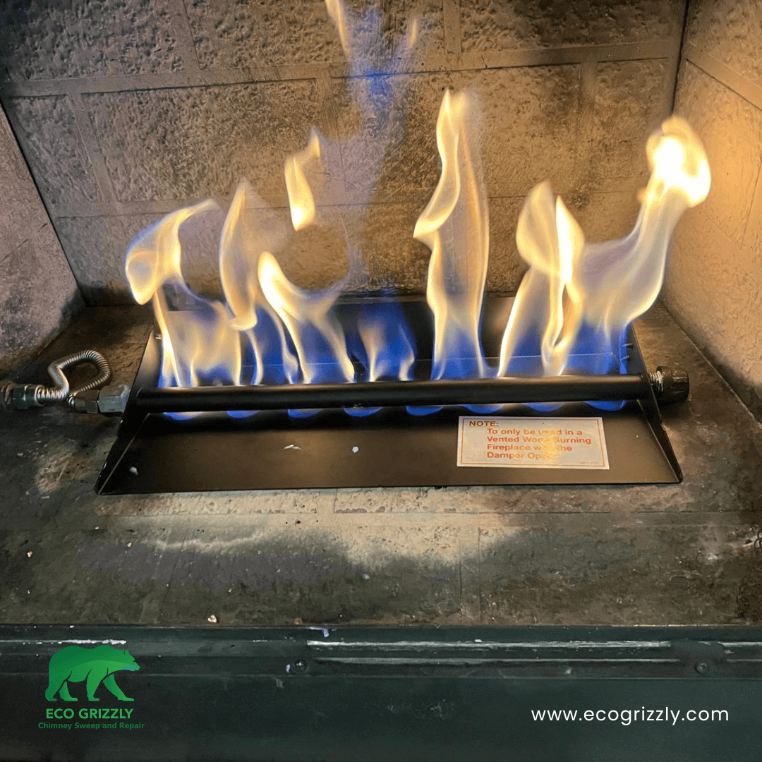 Gas burner pan system installed inside a fireplace for even flame distribution
