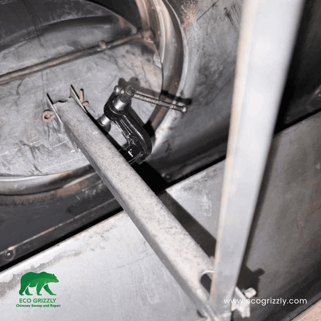 Damper clamp repair restoring proper flue control to a residential fireplace