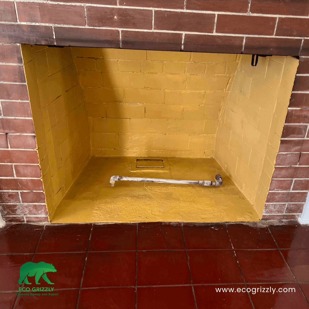 Firebox interior coated with refractory cement for heat protection and longevity