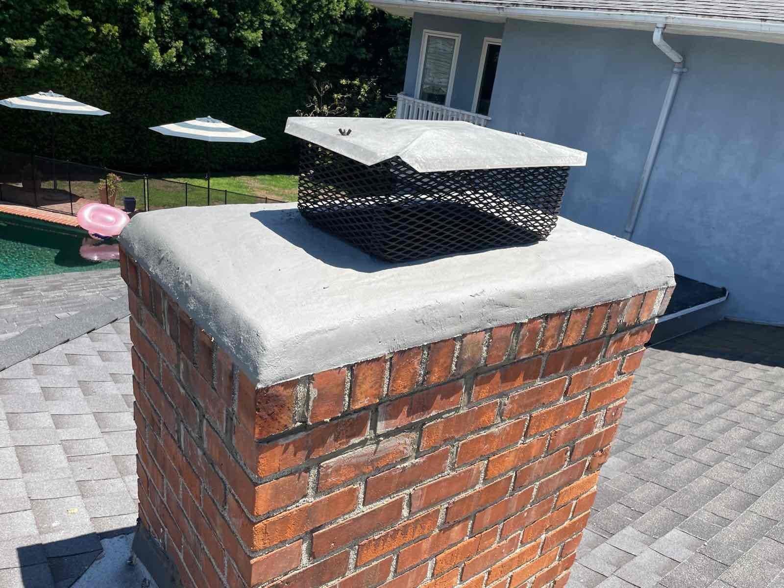 Chimney crown showing cracks and wear before resurfacing repair