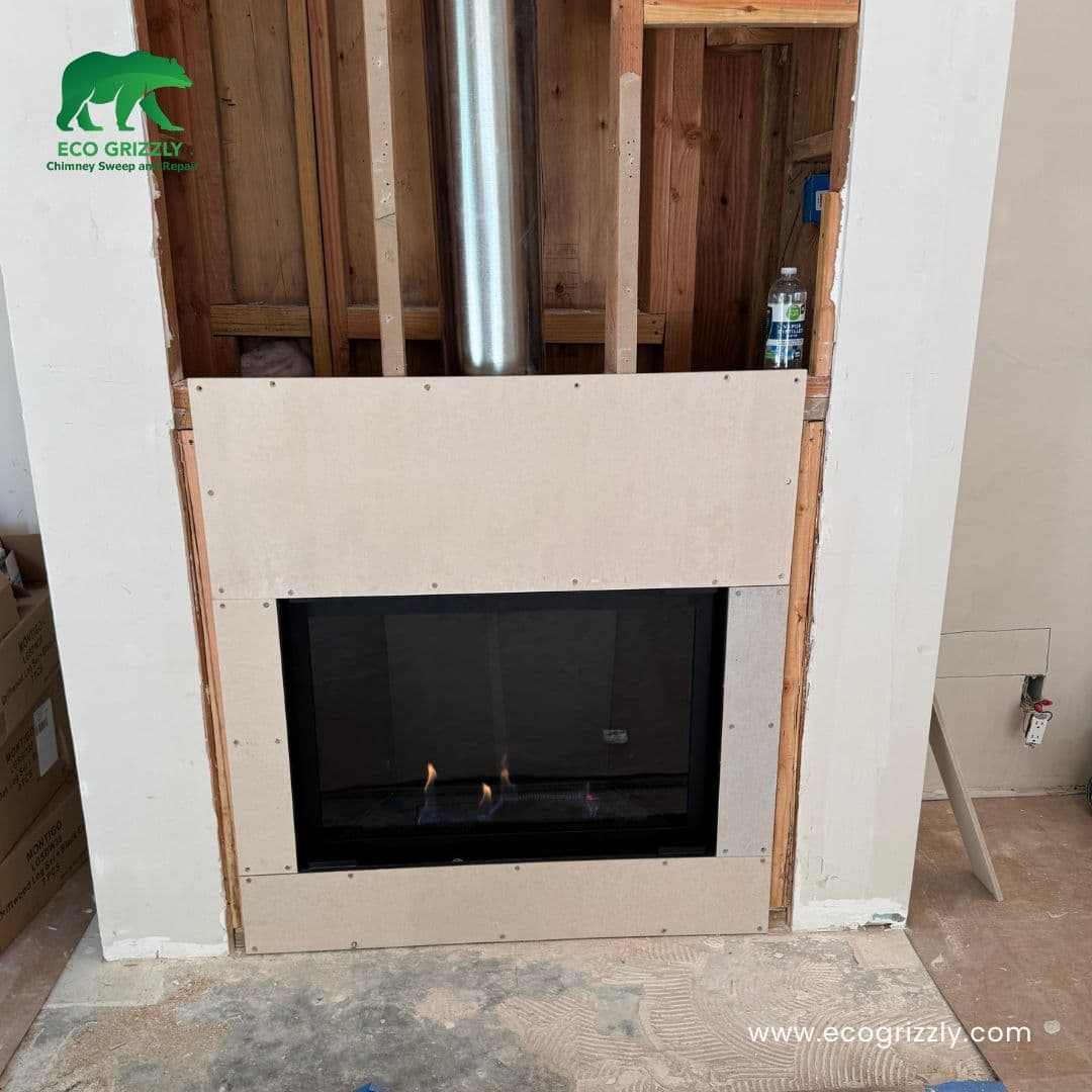 Fireplace insert framing and installation phase with surround being fitted