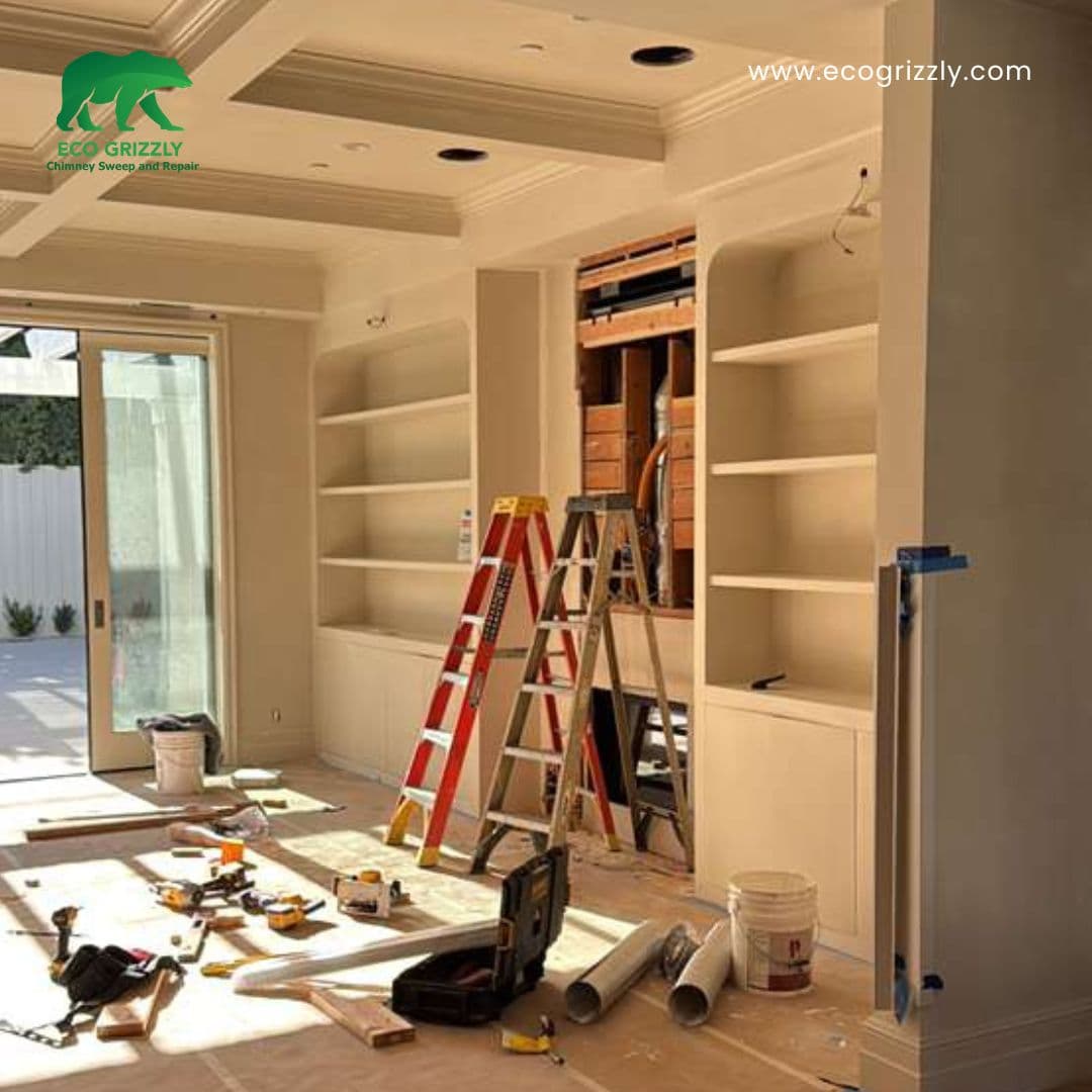 Site preparation for a fireplace insert job with drop cloths and tools in place