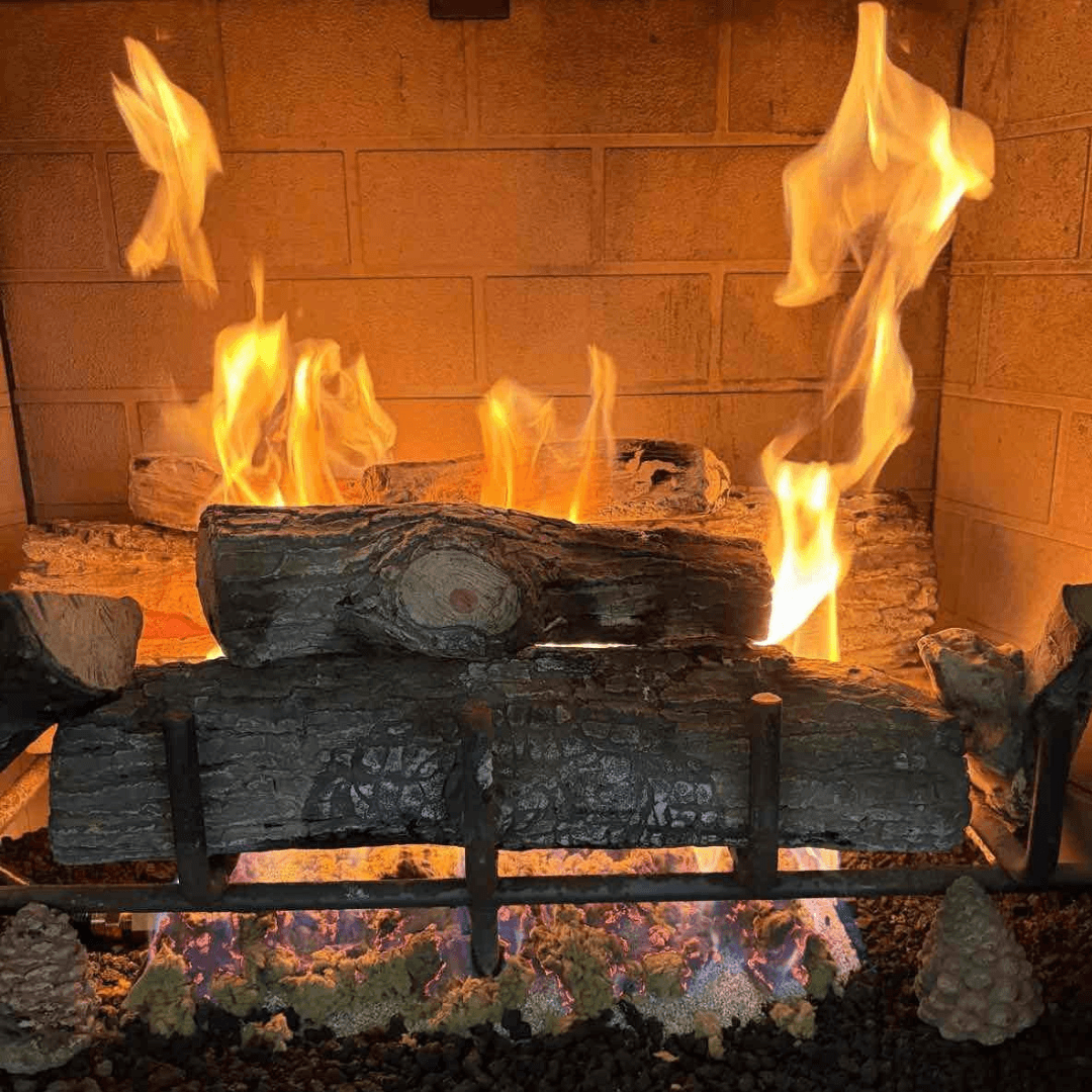 Premium gas logs installed in an arched brick fireplace with blue flame base