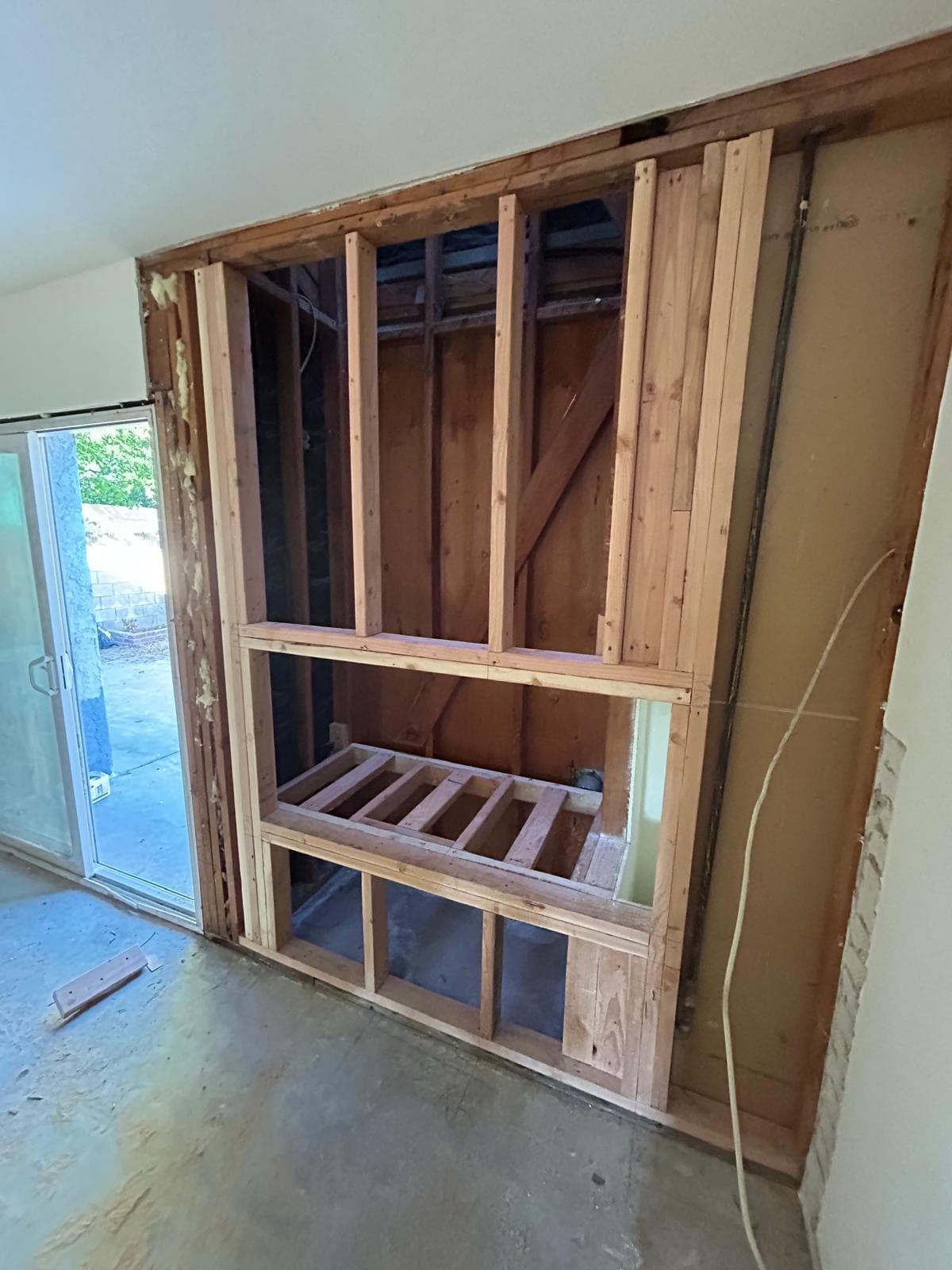 Framing phase for electric fireplace remodel in residential living room