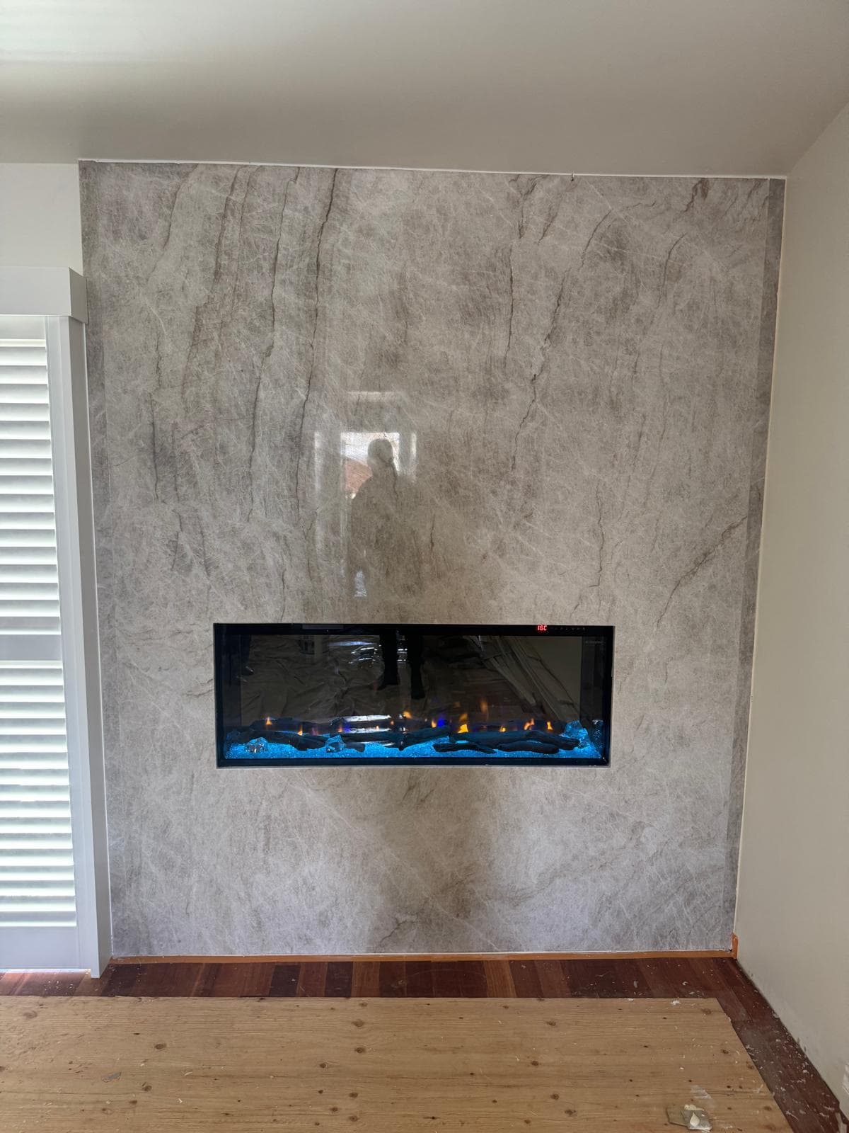 Electric fireplace installation with stone slab surround by Eco Grizzly