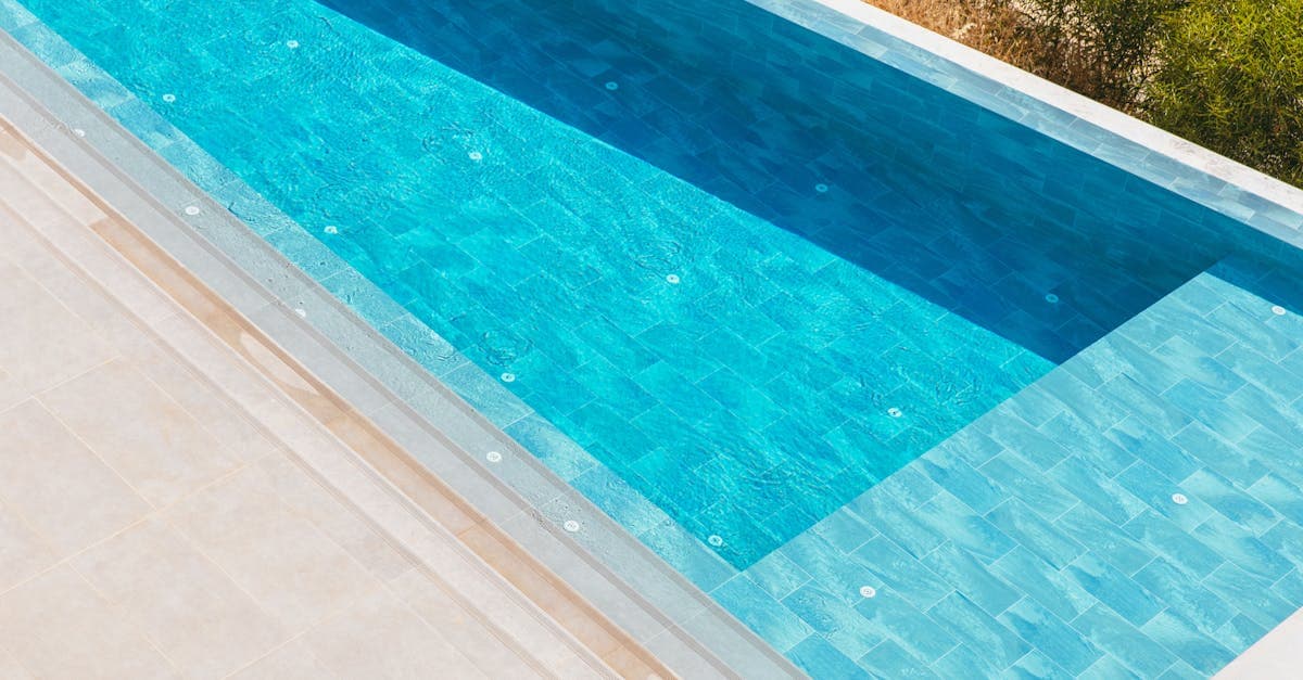 Aerial view of a renovated swimming pool with updated deck and finish