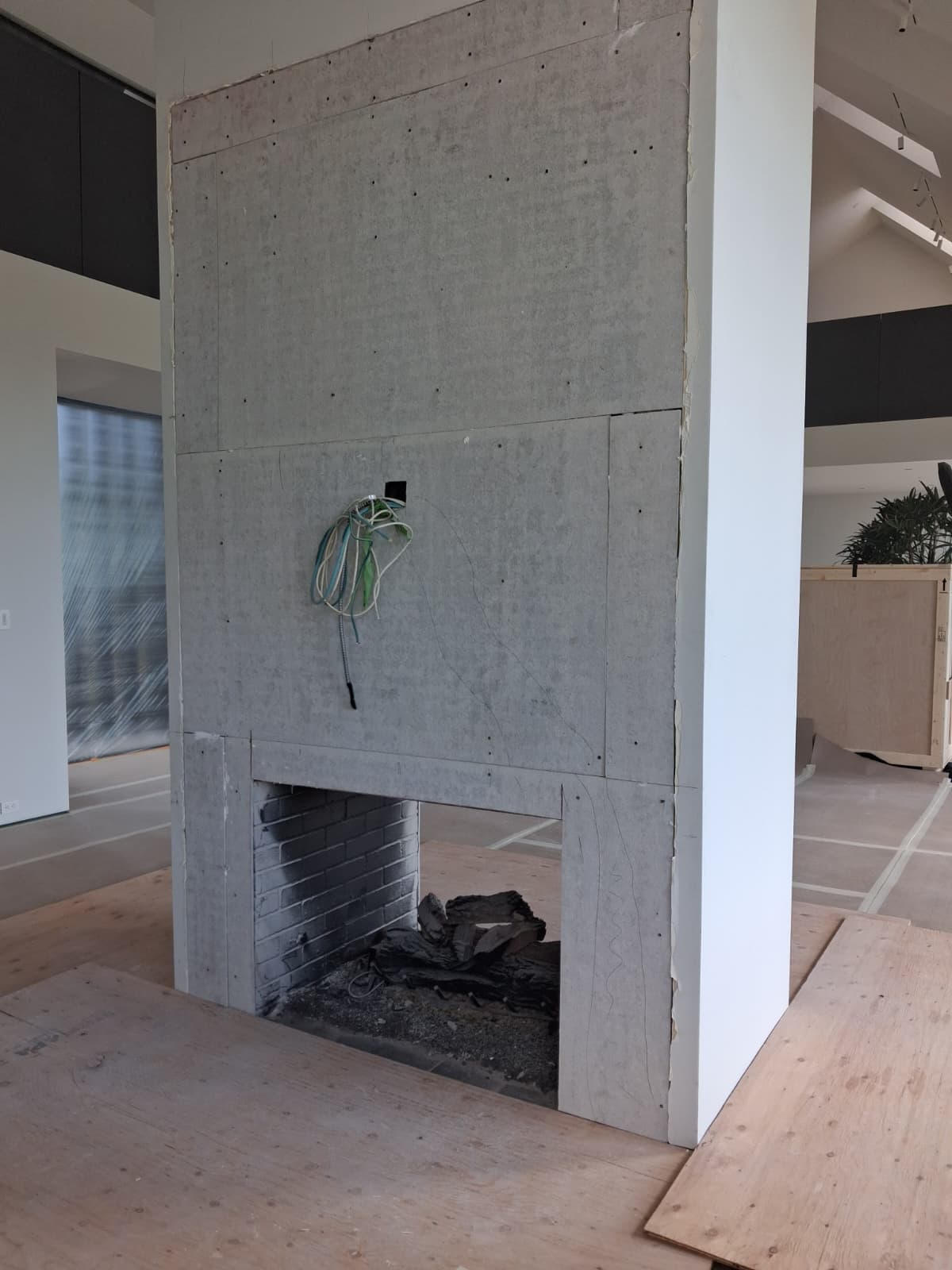 Fireplace column fully wrapped in new cement board with taped seams and the firebox opening left open