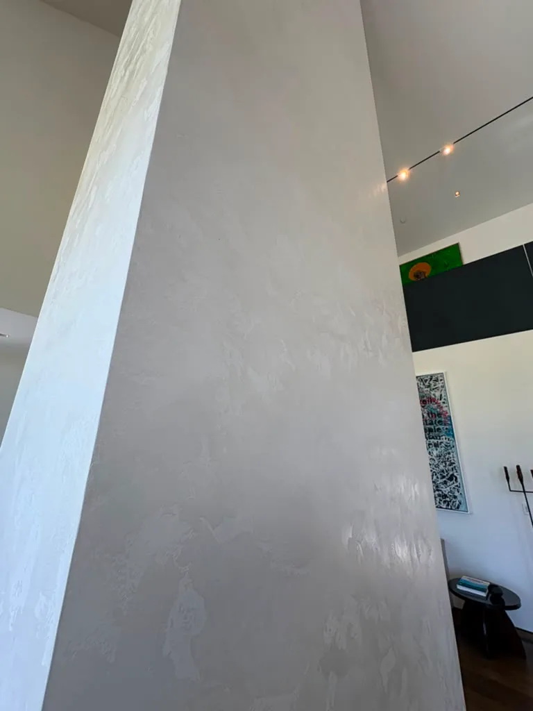 Close view of the smooth off white Venetian plaster finish on the fireplace column