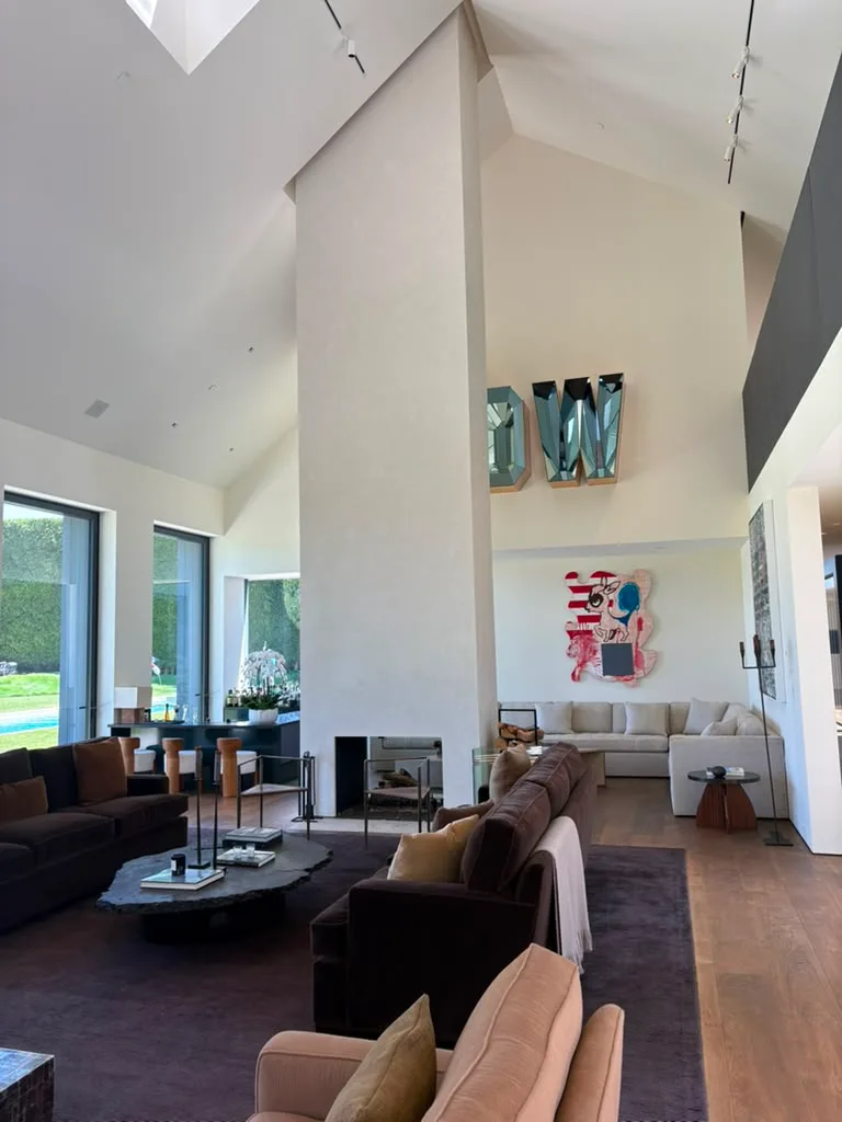 Finished fireplace column seen across the seating area with skylight and artwork