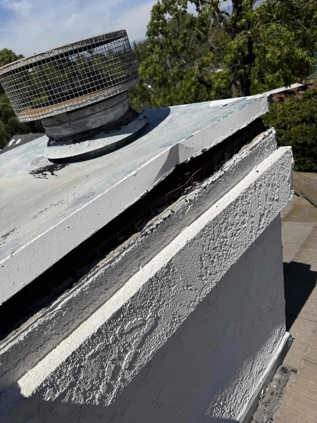 Old chase cover pulling away from the stucco chimney, leaving an open gap along the top edge
