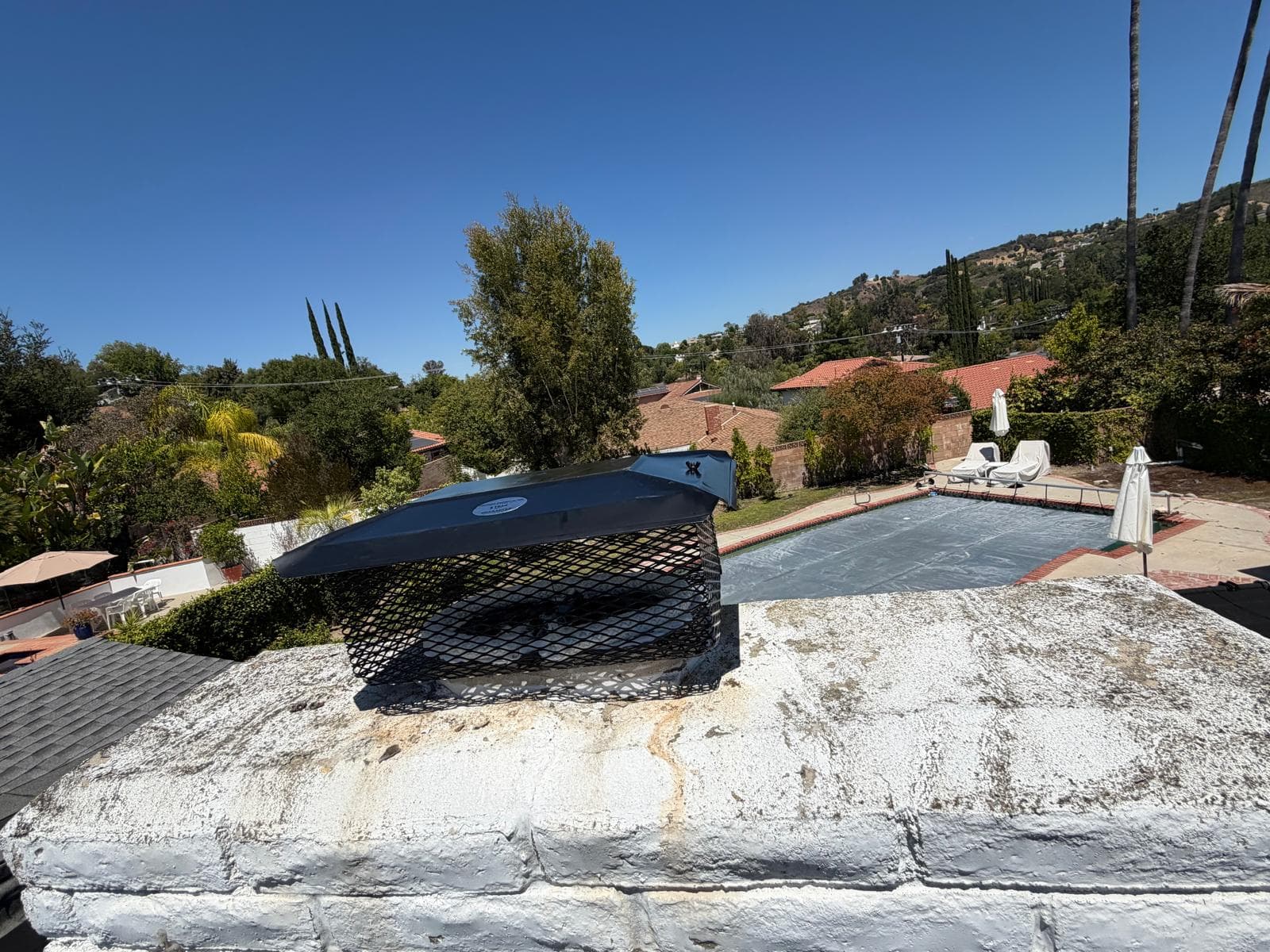 Second angle view of completed chimney cap and damper installation