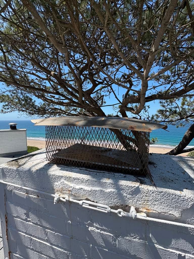 Chimney without cap and with failed damper before replacement