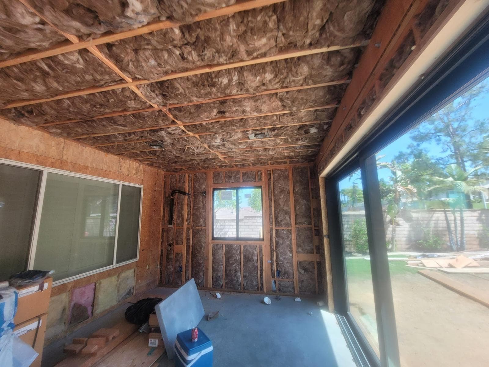 Exterior view of the room addition and patio during construction