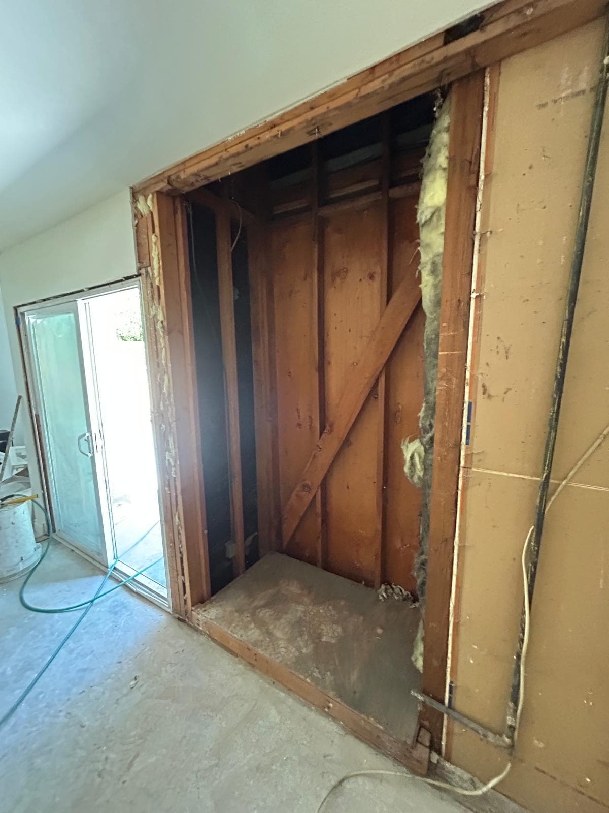 Demolition of old brick fireplace surround during electric fireplace remodel