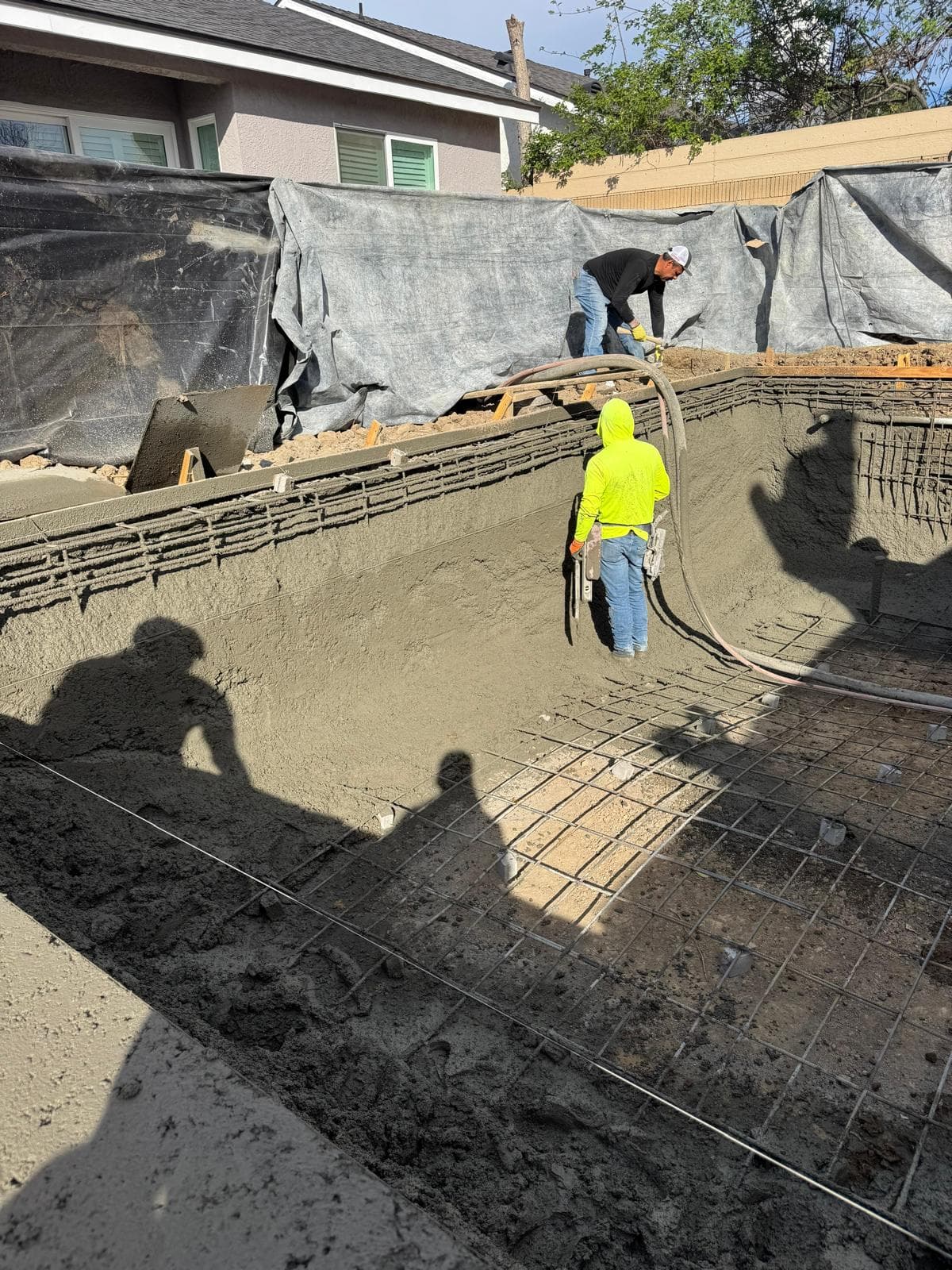 Concrete repair and finishing work on pool shell interior