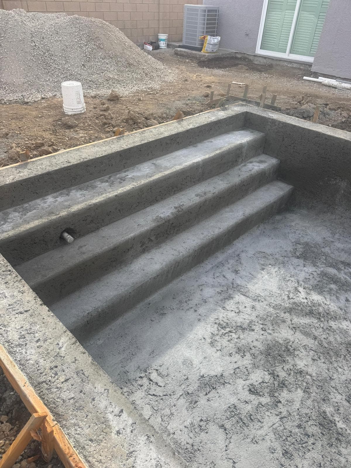 Smooth troweled concrete pool steps inside shell before plaster