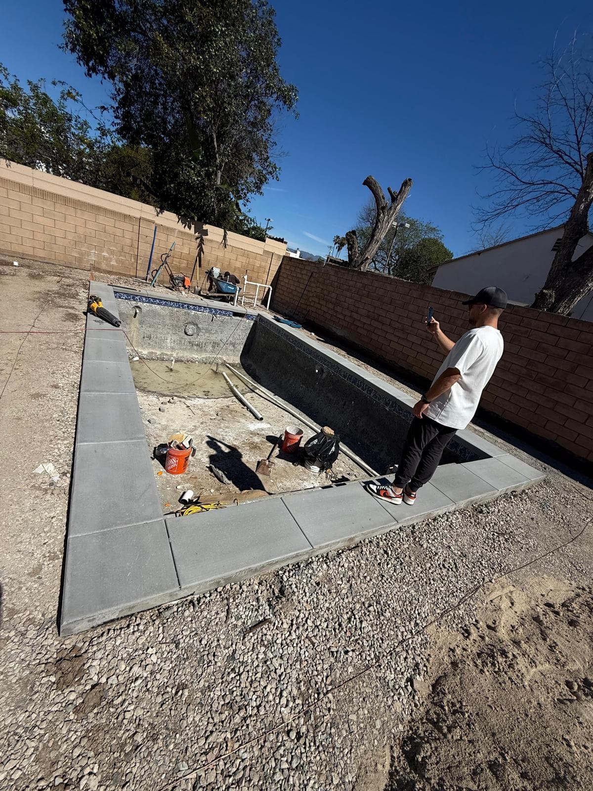Paver deck and coping installation around pool shell