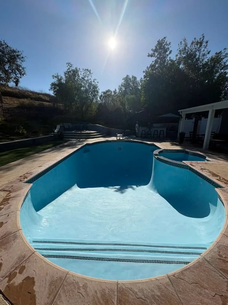 Pool freshly plastered in light blue with the new waterline tile set and ready to fill