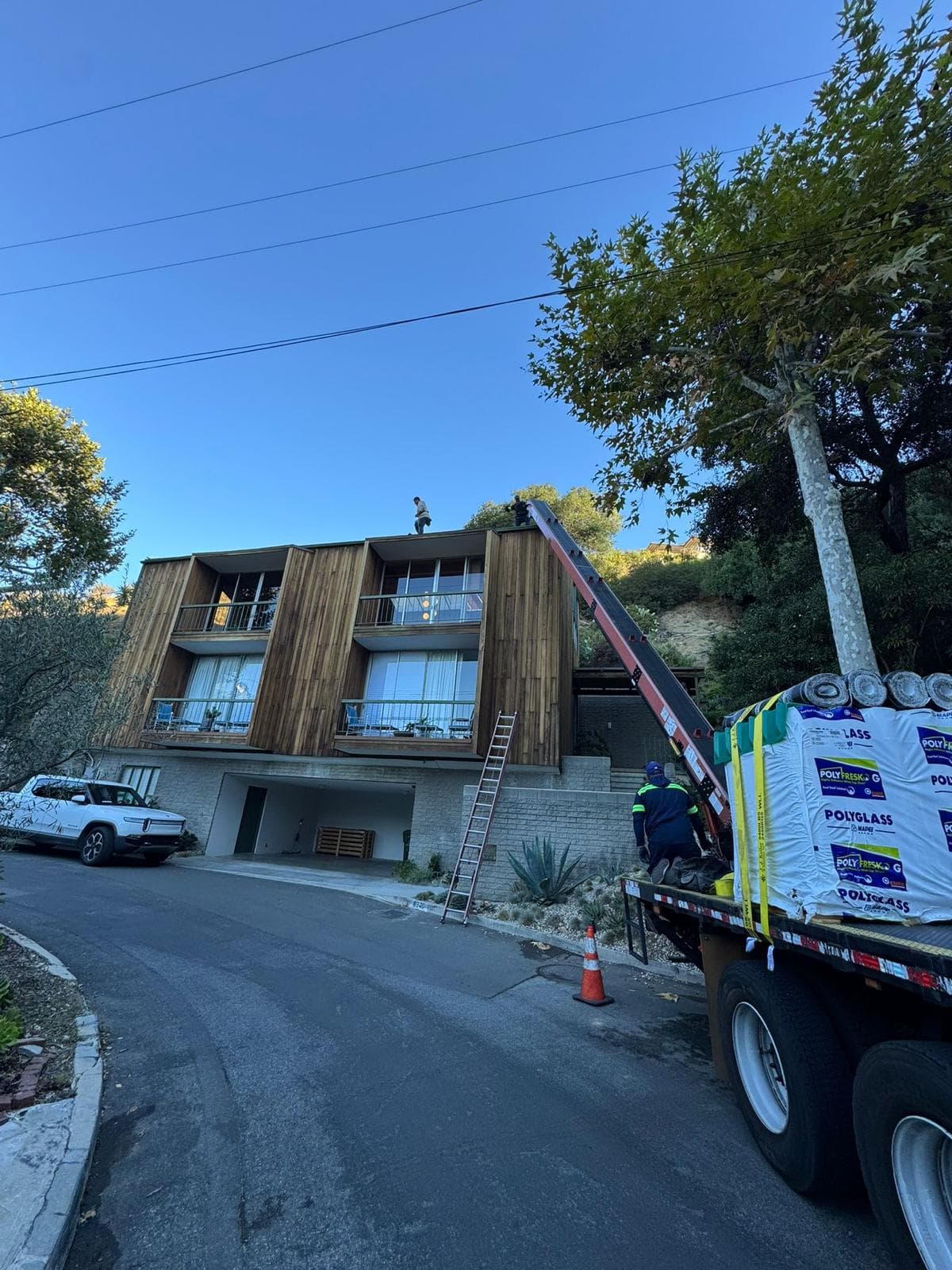 Roof before installation showing bare deck and old materials