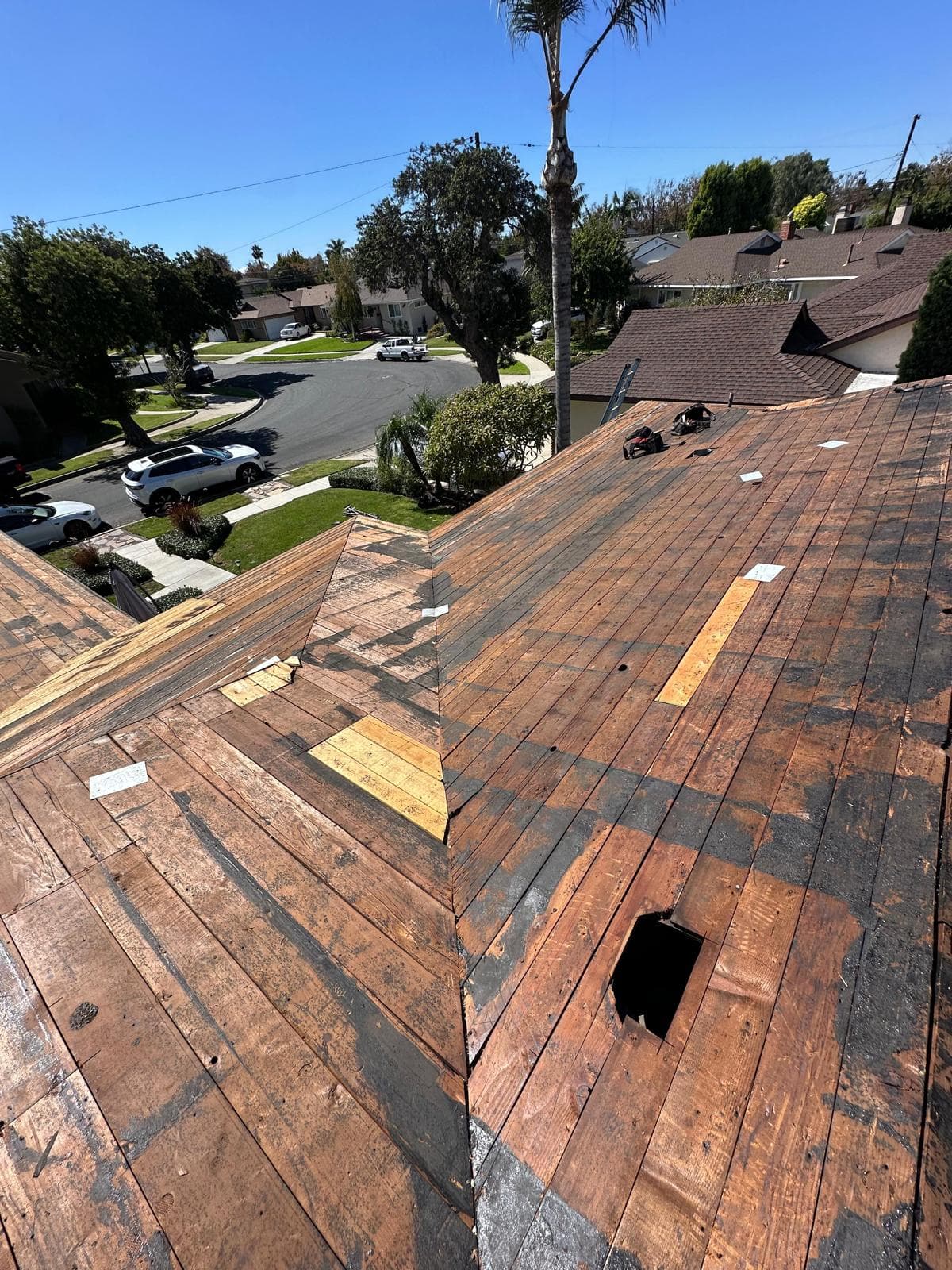 Damaged roof before tear-off and replacement showing worn shingles