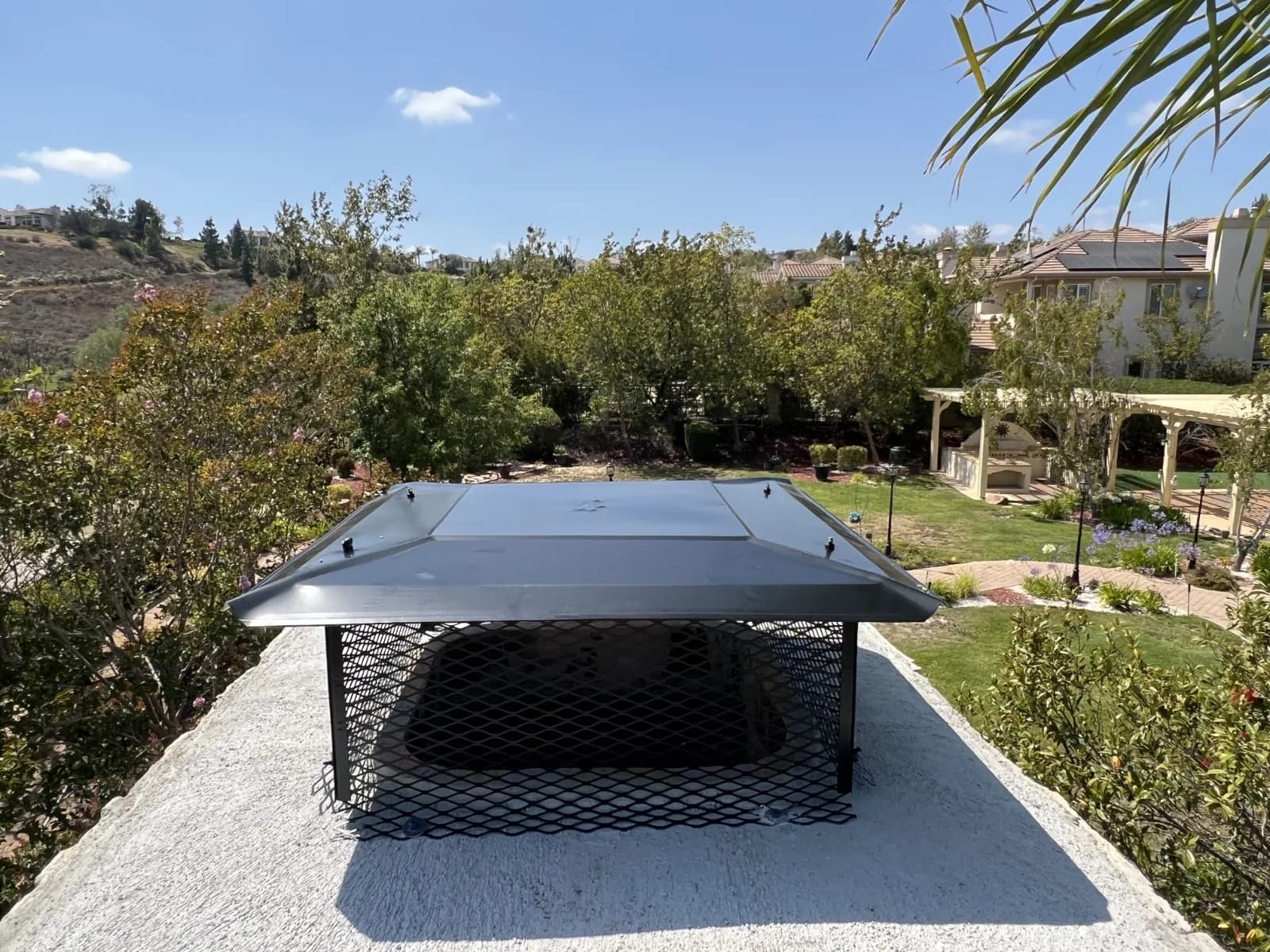 Second view of completed custom chimney cap installation from a different angle