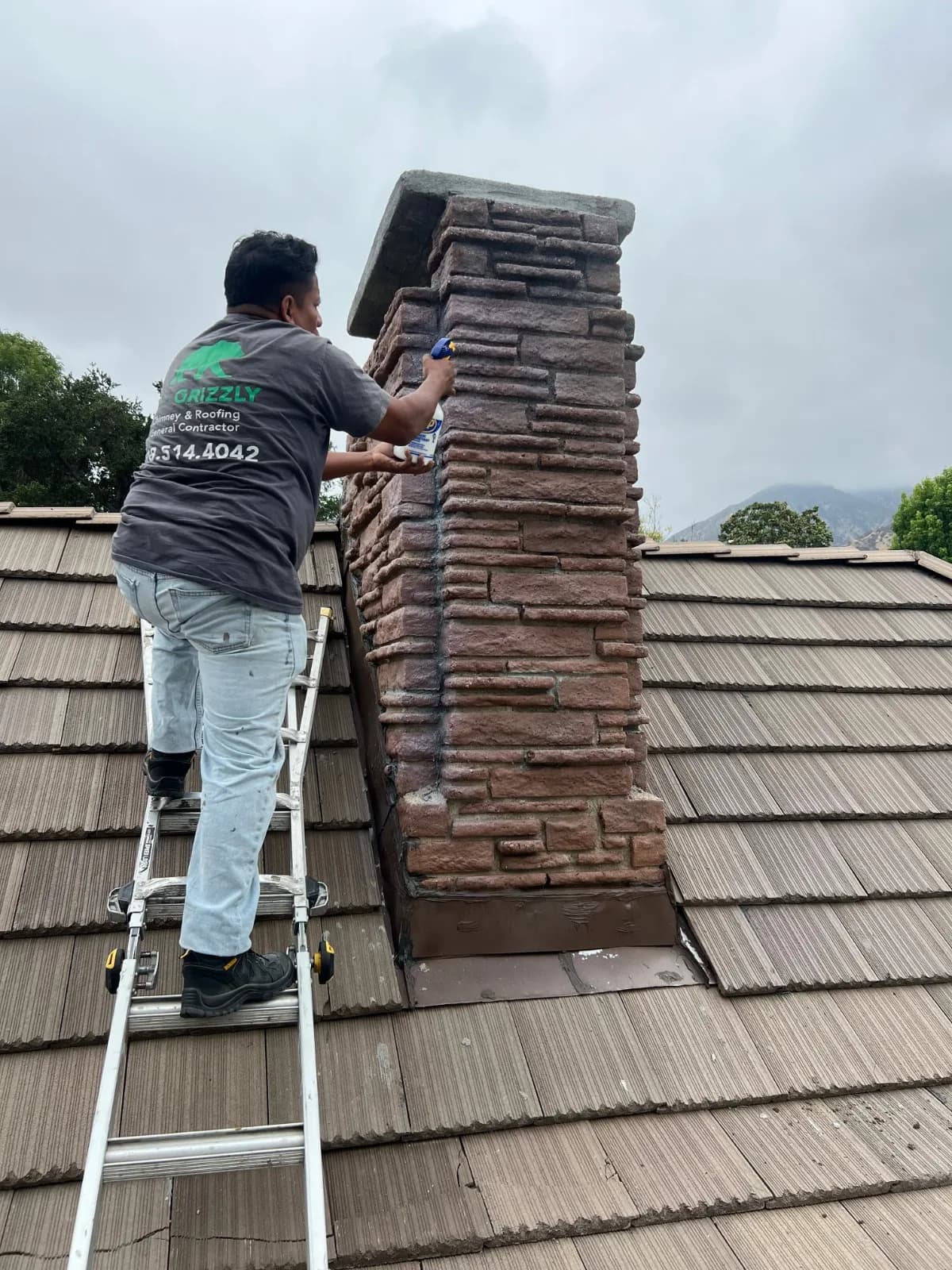 Chimney masonry after crack repairs and waterproofing sealant application showing sealed brick surface