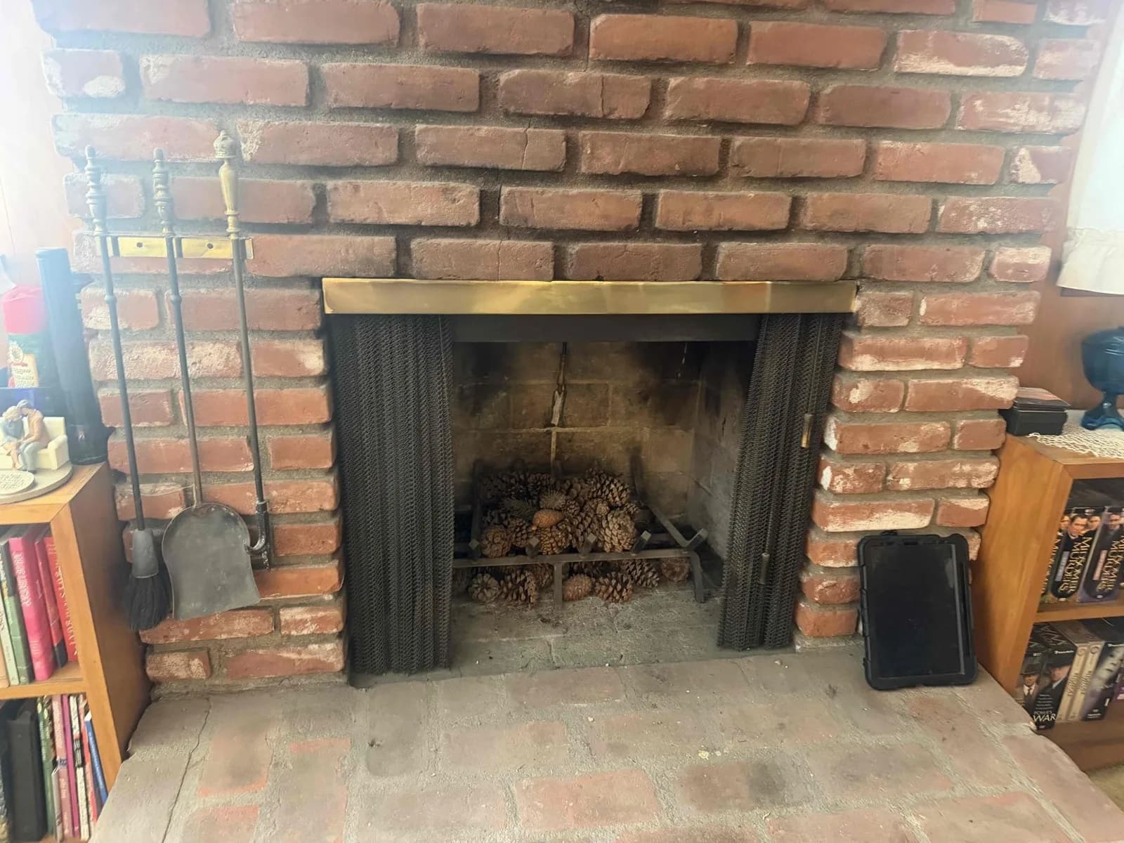 Aging log lighter with surface rust in a fireplace firebox before replacement