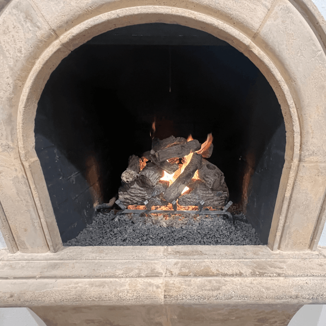 Realistic gas log set installed in a brick fireplace with warm flame pattern