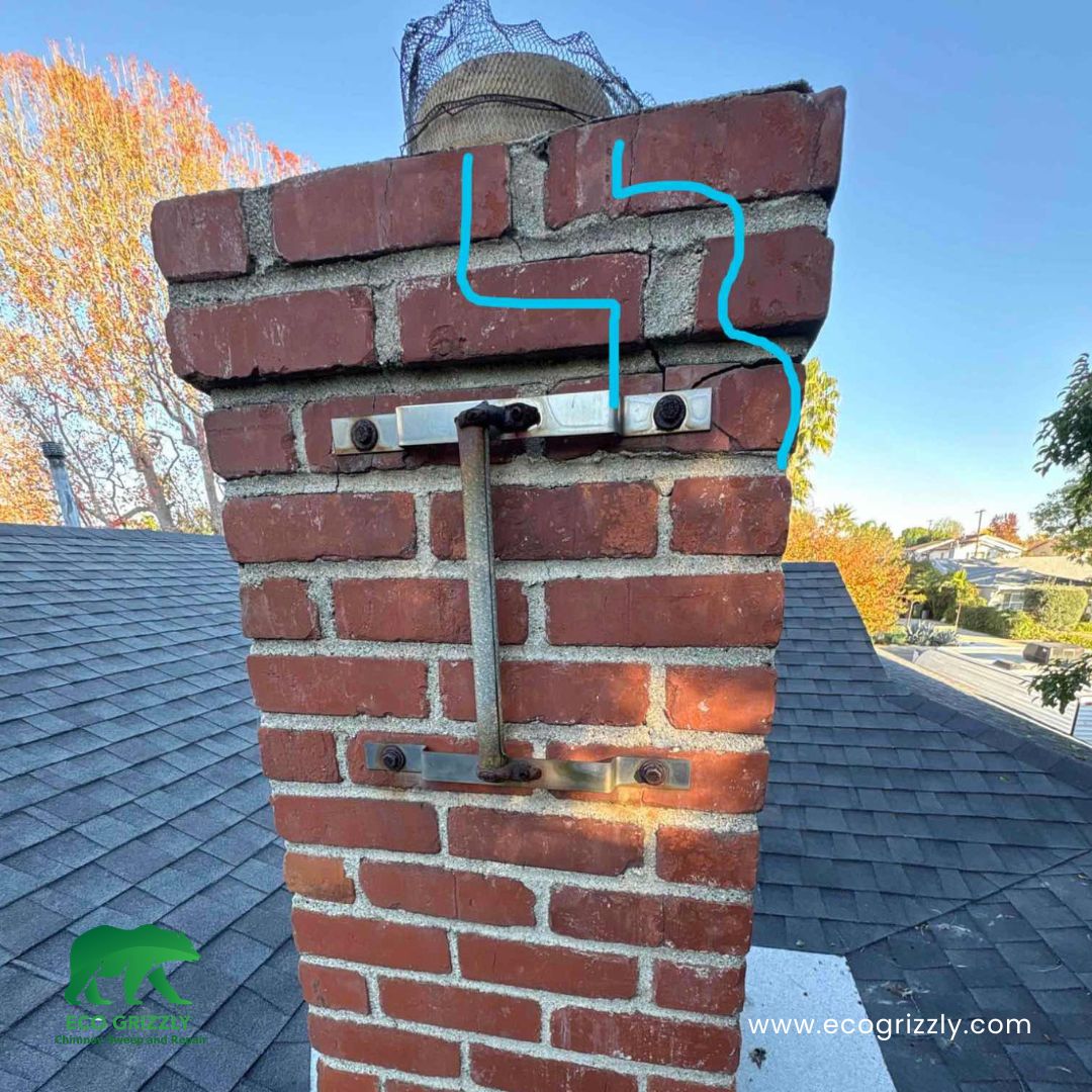 Technician identifying cracks and damage in a brick chimney during inspection