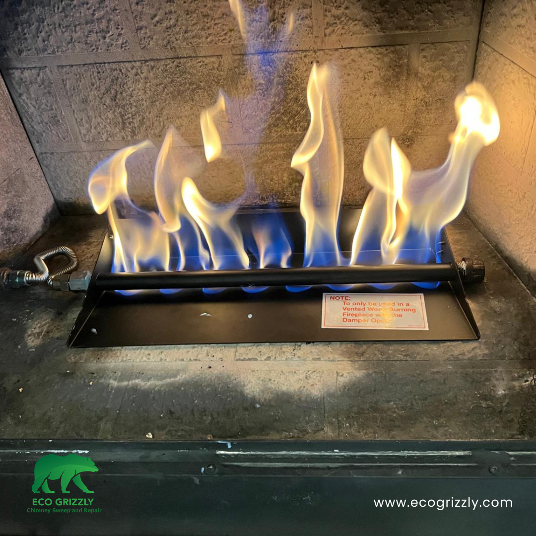 Gas burner pan system installed inside a fireplace for even flame distribution