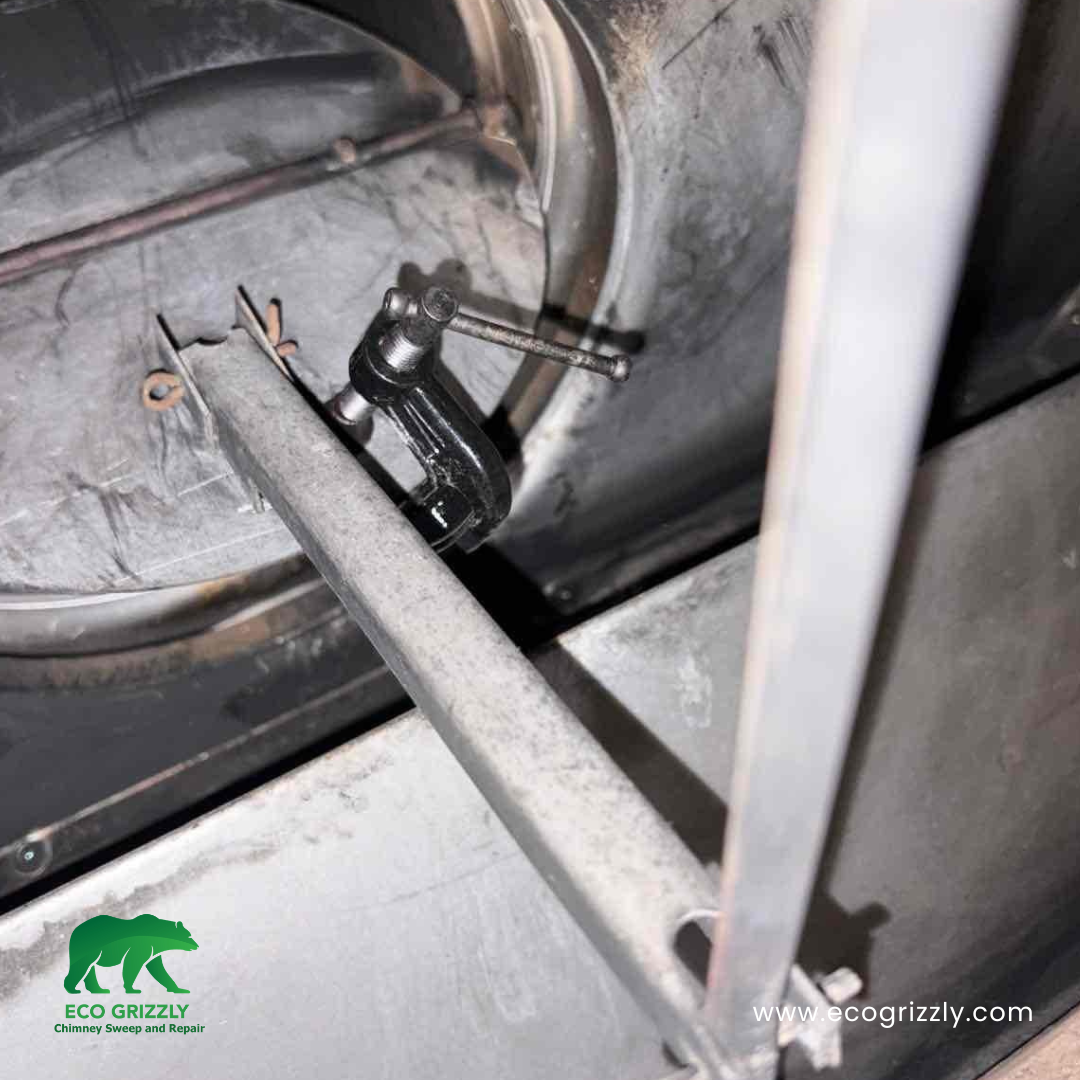 Damper clamp repair restoring proper flue control to a residential fireplace