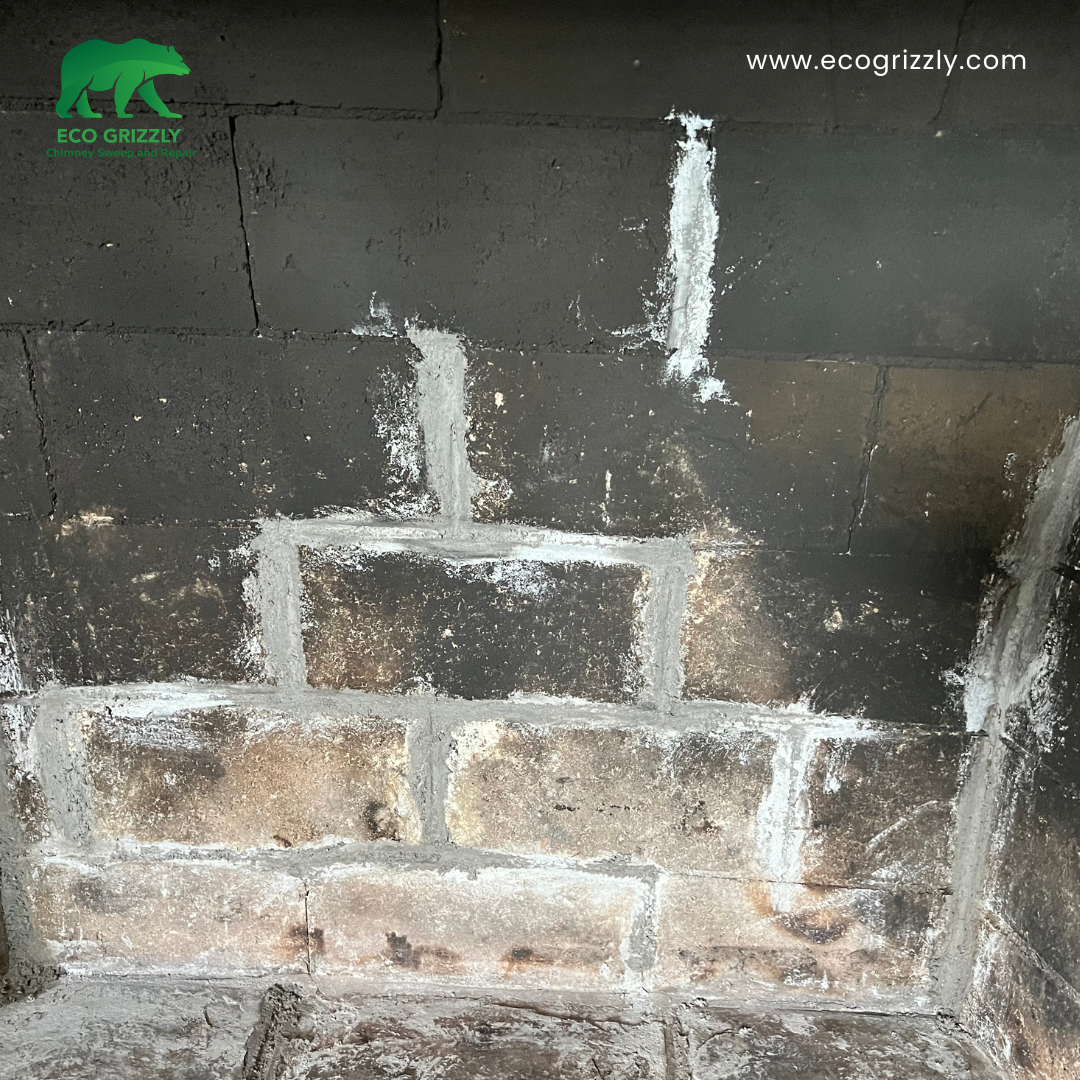 Firebox back wall repair with new firebrick replacing cracked and spalled material