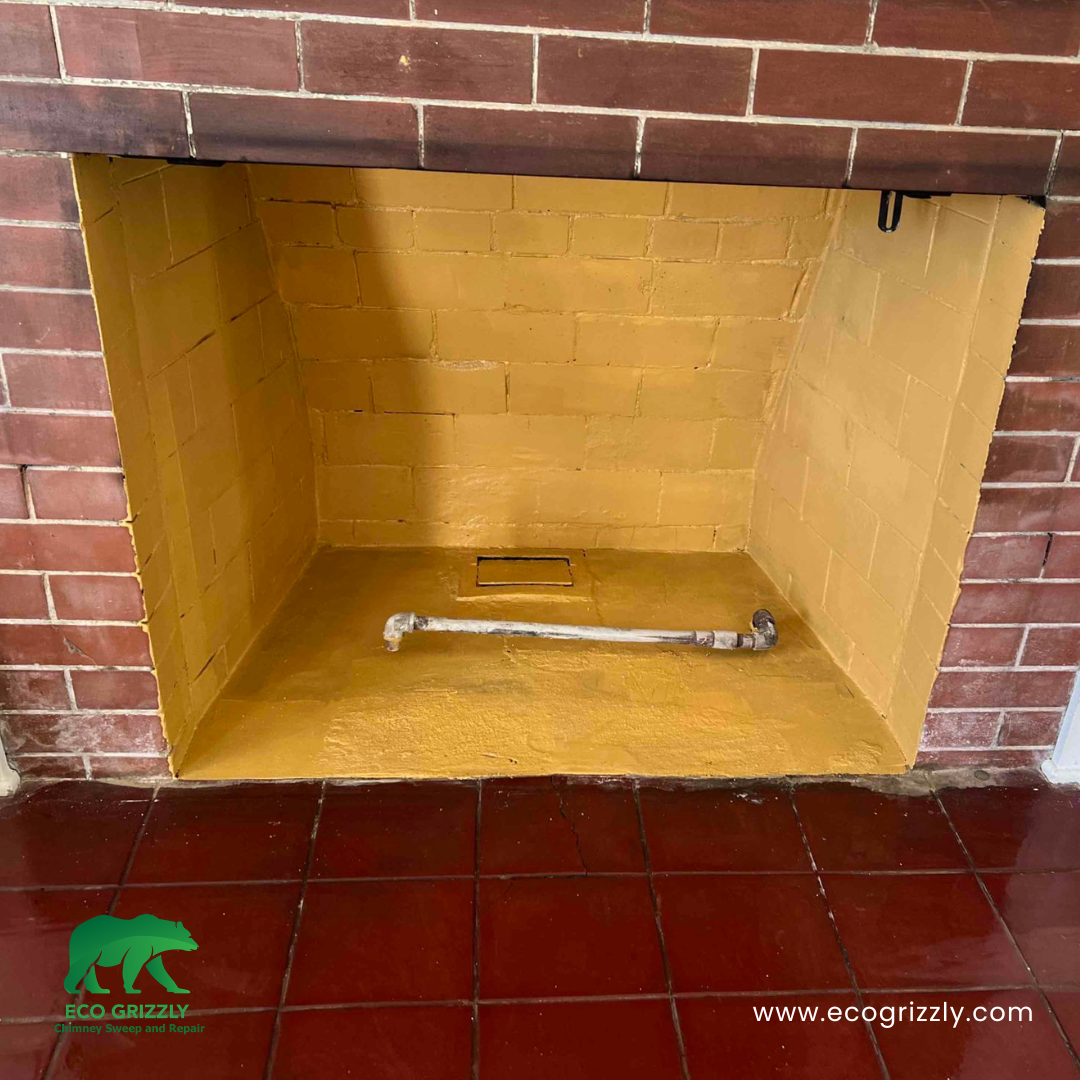 Firebox interior coated with refractory cement for heat protection and longevity
