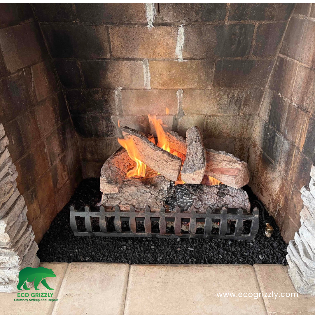 Deep chimney cleaning with gas logs visible showing full firebox and flue service