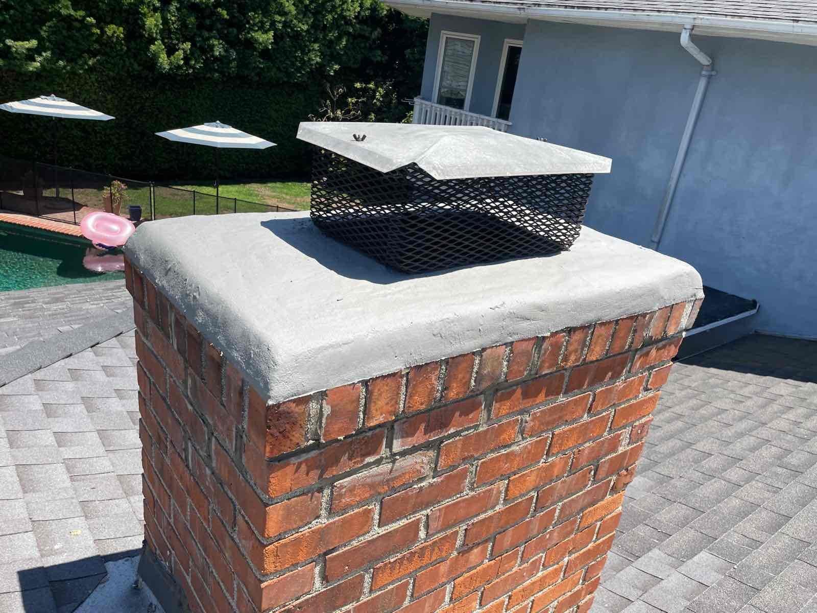 Chimney crown showing cracks and wear before resurfacing repair