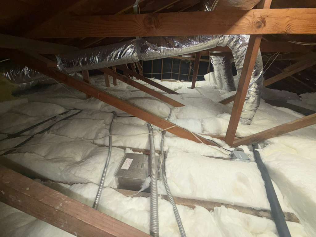 Attic with fresh blown-in insulation installed to code